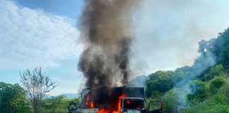 Trucks burn on the Uruapan-Cuatro Caminos highway.