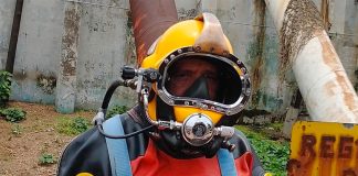 Julio César Cu suited up and ready for a swim in sewage.