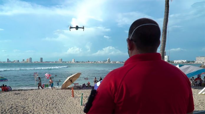 A drone flies over a beach in Mazatlán.