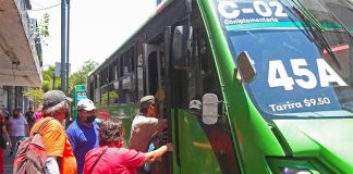 Riders board a public transit bus in Guadalajara.