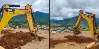 Two backhoes go to work on the heliport.