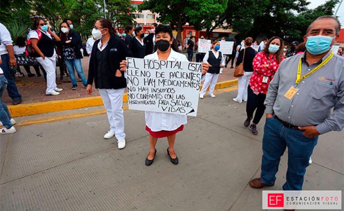 Healthcare workers protest outside a Oaxaca hospital on Tuesday.