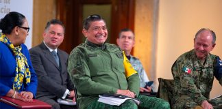 Defense Minister Sandoval enjoys a good laugh during Tuesday's conference.