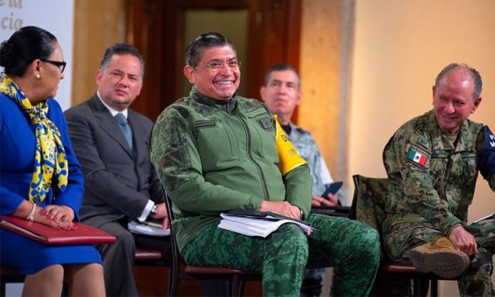 Defense Minister Sandoval enjoys a good laugh during Tuesday's conference.