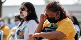 A relative of a victim reacts as members of the marines offer an apology