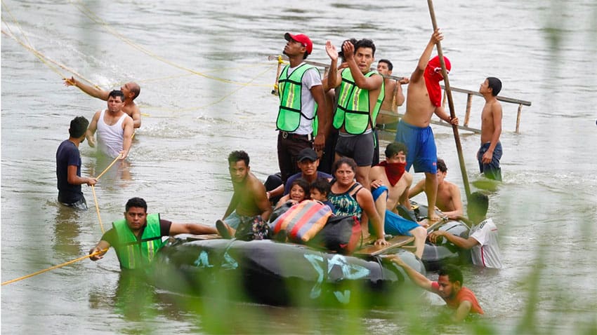 Migrants cross the Suchiate River between Mexico and Guatemala.