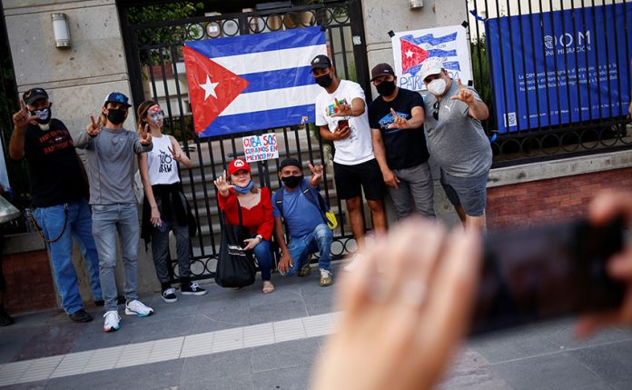 Cubans gesture during a protest against the Cuban government