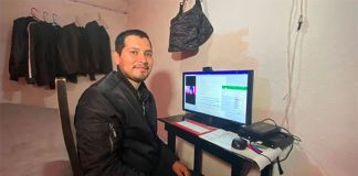 Samuel Olvera sits at his computer at his home in Naucalpan.