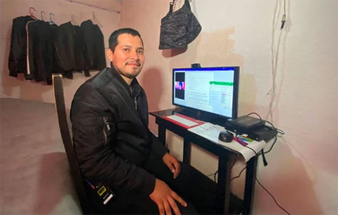 Samuel Olvera sits at his computer at his home in Naucalpan.