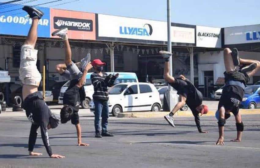 Breakdancing youth at a traffic light in Mazatlán