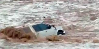 The vehicle from which a woman escaped in a flooded arroyo.