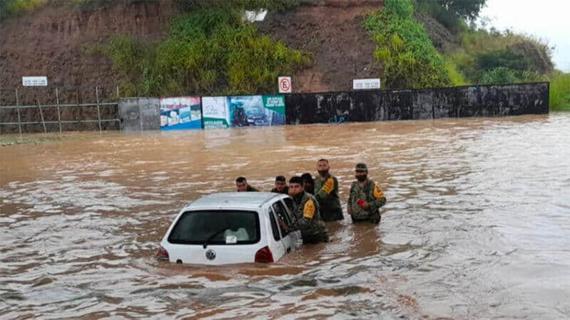 Soldiers arrive to the aid of a vehicle stranded on a flooded road in Veracruz.
