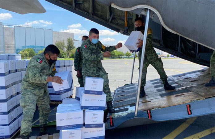 Government personnel load aid supplies onto a plane, in an image shared by the the Foreign Ministry