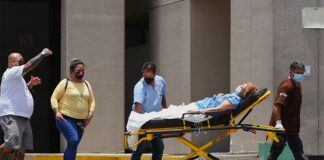 A Covid patient is wheeled into a hospital.