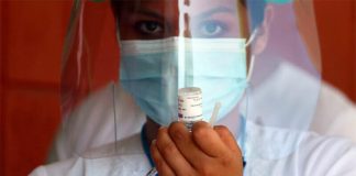 A healthcare worker prepares a Covid-19 vaccine shot.