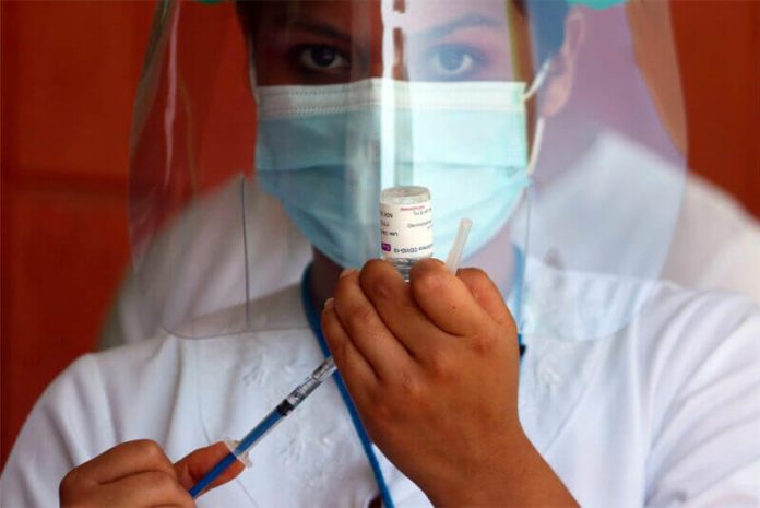 A healthcare worker prepares a Covid-19 vaccine shot.