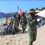 Soldiers patrol an Acapulco beach earlier this year to remind visitors to follow coronavirus precautions.