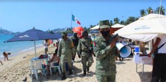 Soldiers patrol an Acapulco beach earlier this year to remind visitors to follow coronavirus precautions.