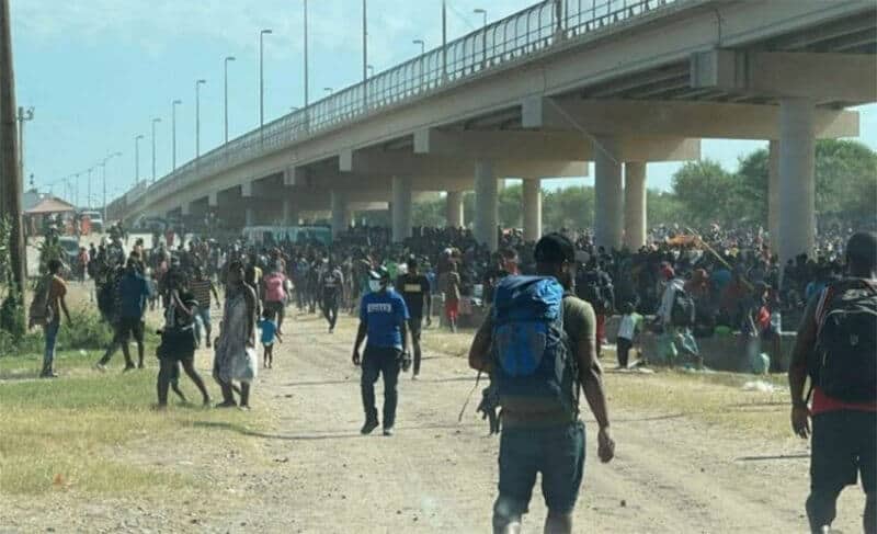 Thousands of migrants, many from Haiti, seek shelter beneath a bridge near Ciudad Acuña.