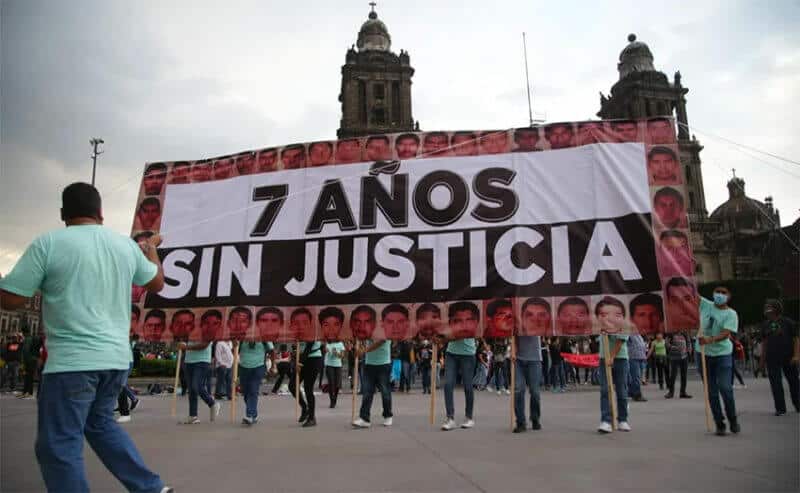 '7 years without justice,' reads a giant banner in the zócalo on Sunday.