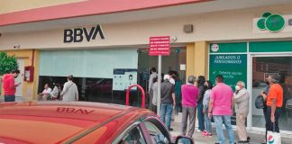 A lineup forms at an ATM Sunday