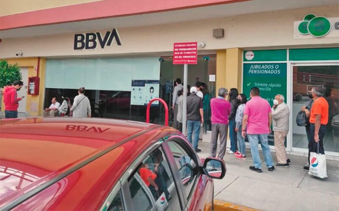 A lineup forms at an ATM Sunday
