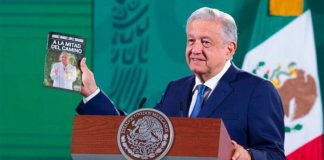lopez obrador displays his new book at Tuesday's mañanera.
