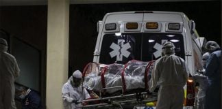 Hospital staff transfer a COVID-19 patient, last December.