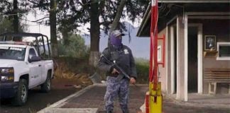 In a still from the documentary, a member of the community's voluntary security force stands guard.
