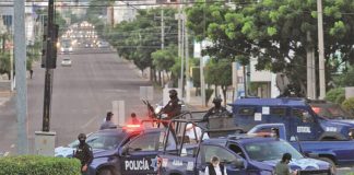 The police pursuit of the gunmen was foiled when the vandals threw metal spikes onto the road that punctured the tires of two police cars.