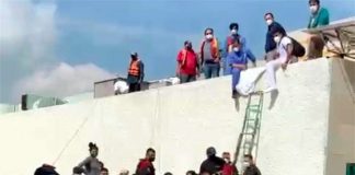 People are evacuated by boat Tuesday from the Tula General Hospital.