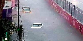 Nearly submerged vehicles on a road in Ecatepec.