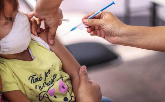 A young child receives a measles shot. Soon, children with certain health conditions will also be eligible for COVID-19 inoculations.