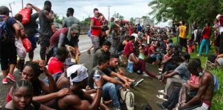 Migrants stop to rest on a Chiapas highway.