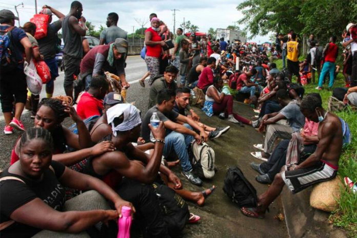 Migrants stop to rest on a Chiapas highway.