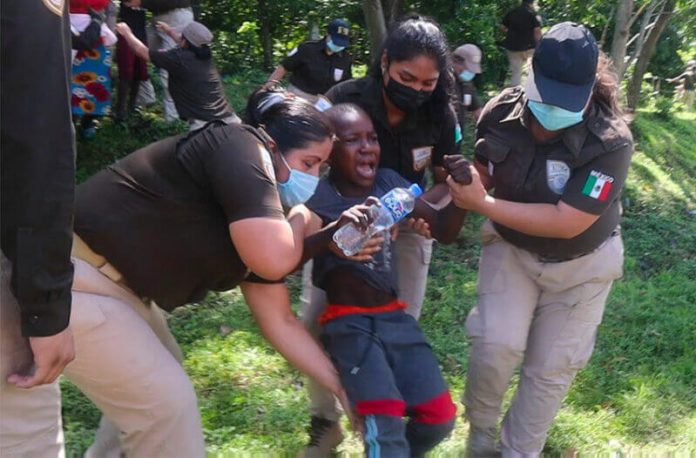 Immigration agents drag a screaming youngster out of the woods in Chiapas on Thursday.