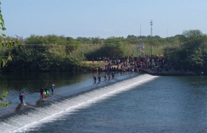 Migrants make their way across the Rio Grande near Ciudad Acuña.