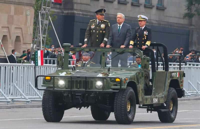 The president rides in the military parade in Mexico City Thursday with the the heads of the armed forces.