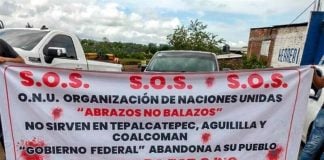 A banner declares an S.O.S. in Apatzingán on Sunday.