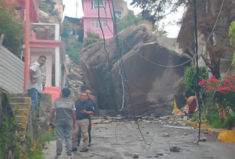 A huge boulder blocks a road in Tlalnepantla.