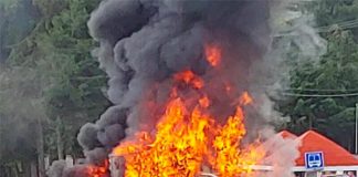 A delivery truck burns at a highway blockade in Michoacán