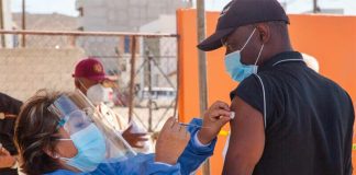 A migrant is vaccinated in Tijuana last month.