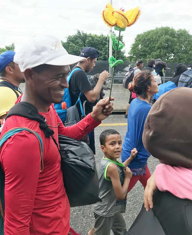 A young boy clutches the shirt of an adult as he marches with fellow migrants in Chiapas on Monday.