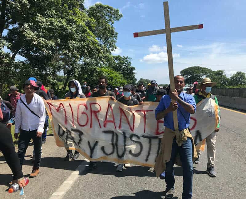 Víctor Manolo Contreras of El Salvador carries the cross at the head of the caravan.
