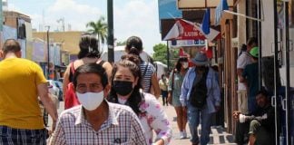 Residents with face masks make their way through downtown Hermosillo, Sonora.