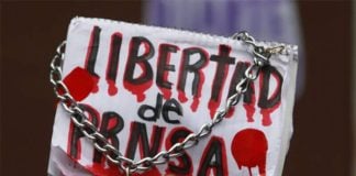 A protestor displays a sign reading "Freedom of the press," at a 2016 protest against violence against journalists in Mexico City.