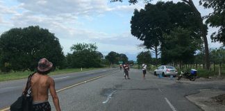 A lone migrant heads north on a highway in Chiapas.