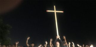 Migrants say a prayer together before leaving Huixtla early Wednesday morning
