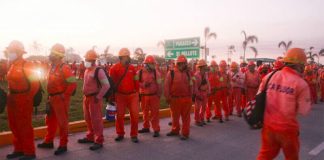 Workers line up for their shift at the Tabasco refinery.