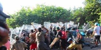 Migrants take on the National Guard on a highway in Chiapas.